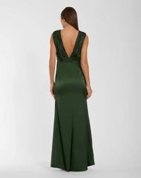 A woman wearing a floor-length dark green satin gown, shown from the back against a light gray studio background.