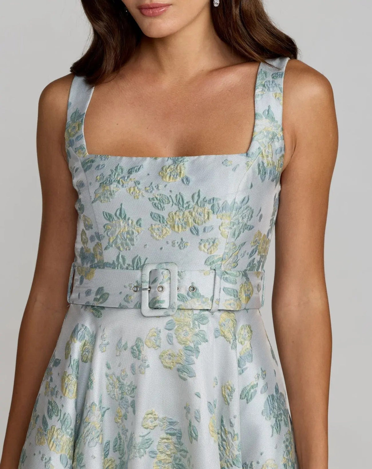 Detailed macro view of the matching waist belt and the intricate blue and green weave of the textile, showcasing the hidden side pocket placement.