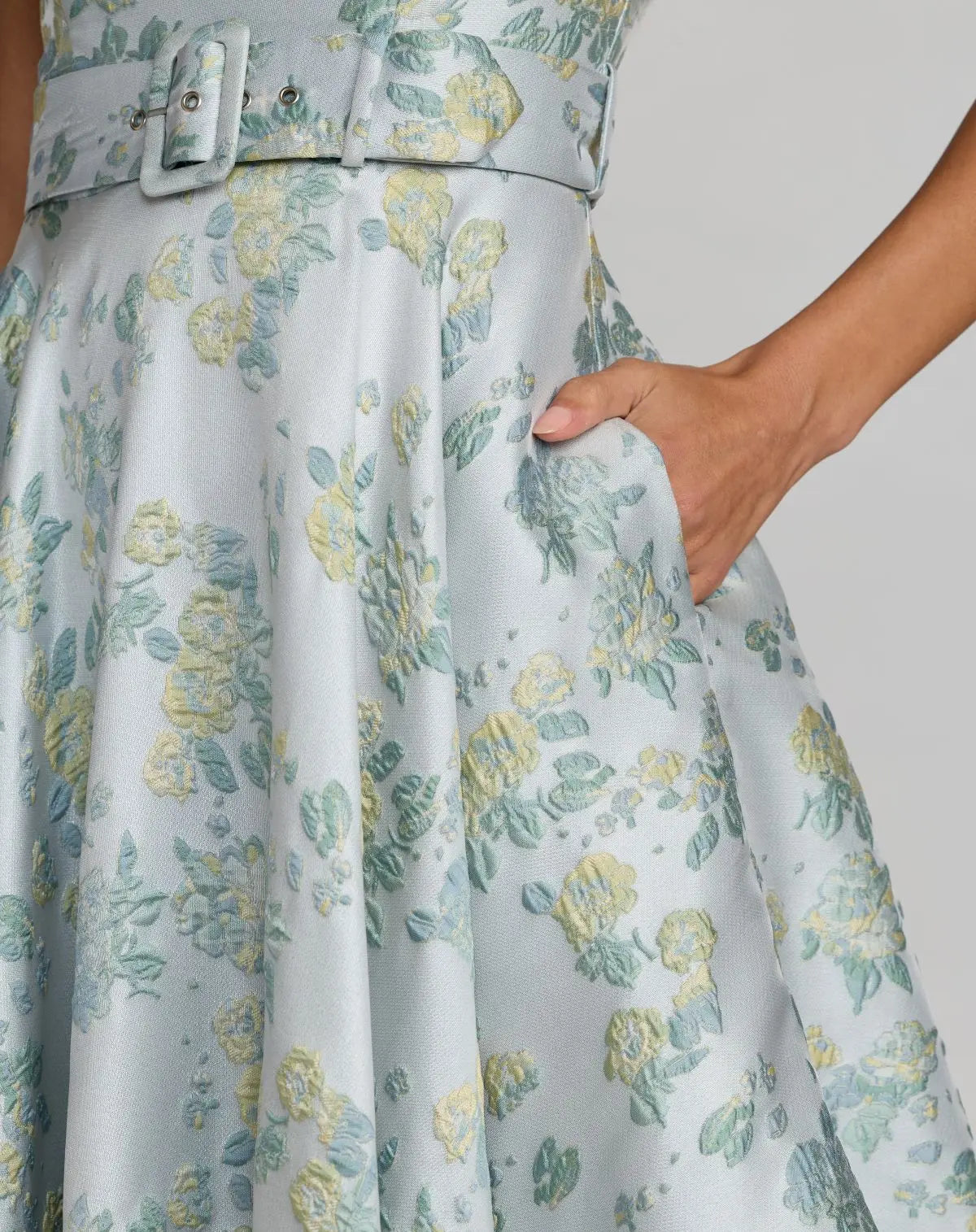 Close-up studio shot focusing on the crisp square neckline and the high-end woven texture of the floral brocade fabric.
