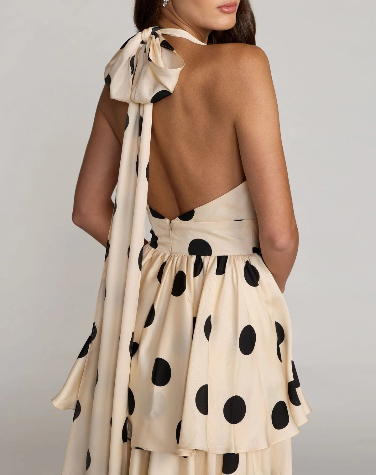 Alternate back angle lifestyle view highlighting the sleeveless profile and elegant drape of the charmeuse fabric.