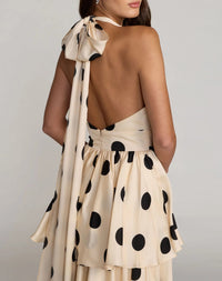 Alternate back angle lifestyle view highlighting the sleeveless profile and elegant drape of the charmeuse fabric.