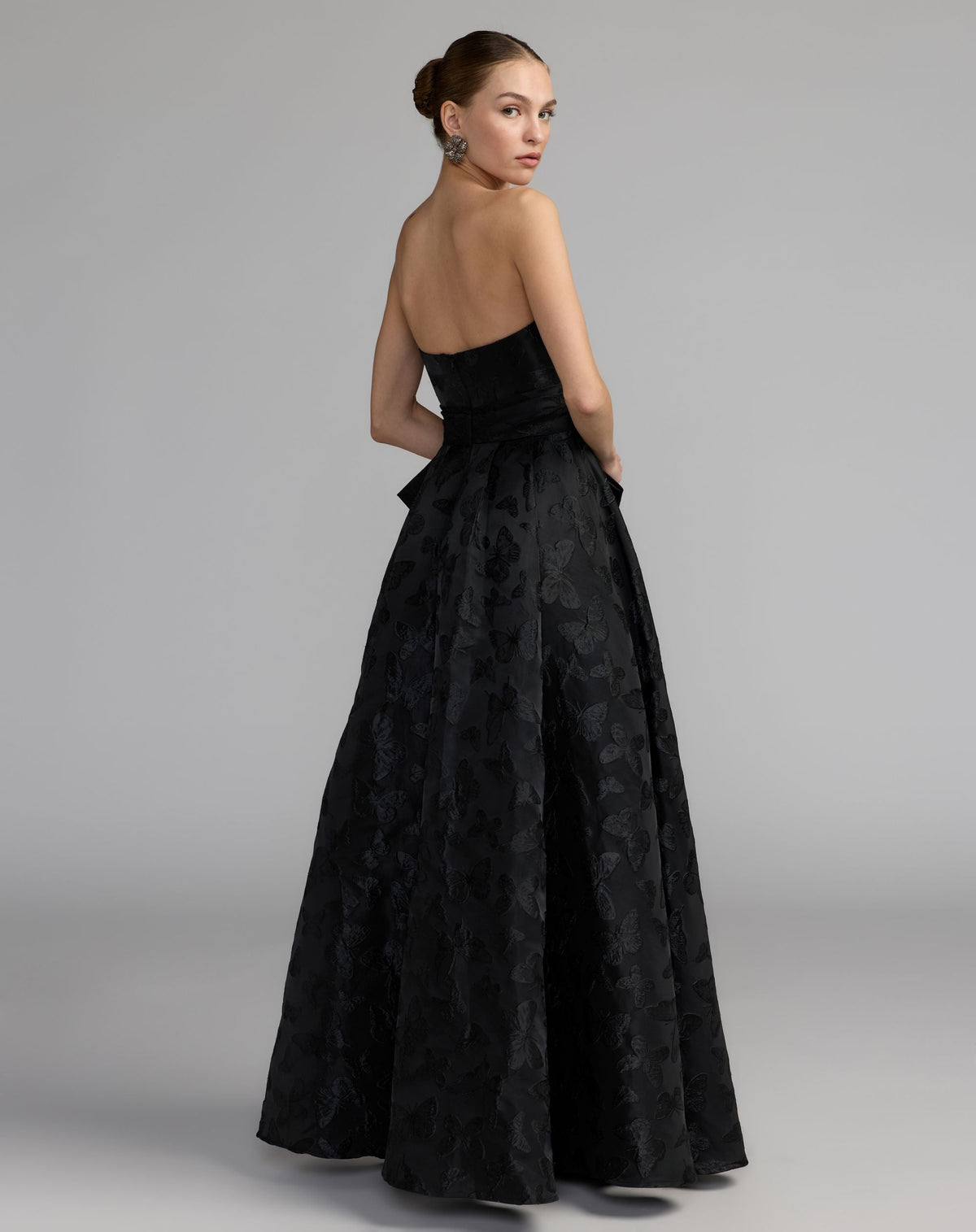 Mac Duggal #37097 black strapless brocade a-line gown with bow back view