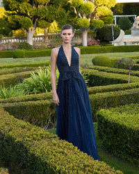 Full length view of Mac Duggal 37120 midnight gown in a garden
