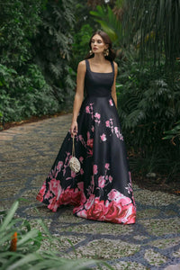 Editorial shot of model wearing black sleeveless gown with square neckline and floral embroidery, style 37149, 