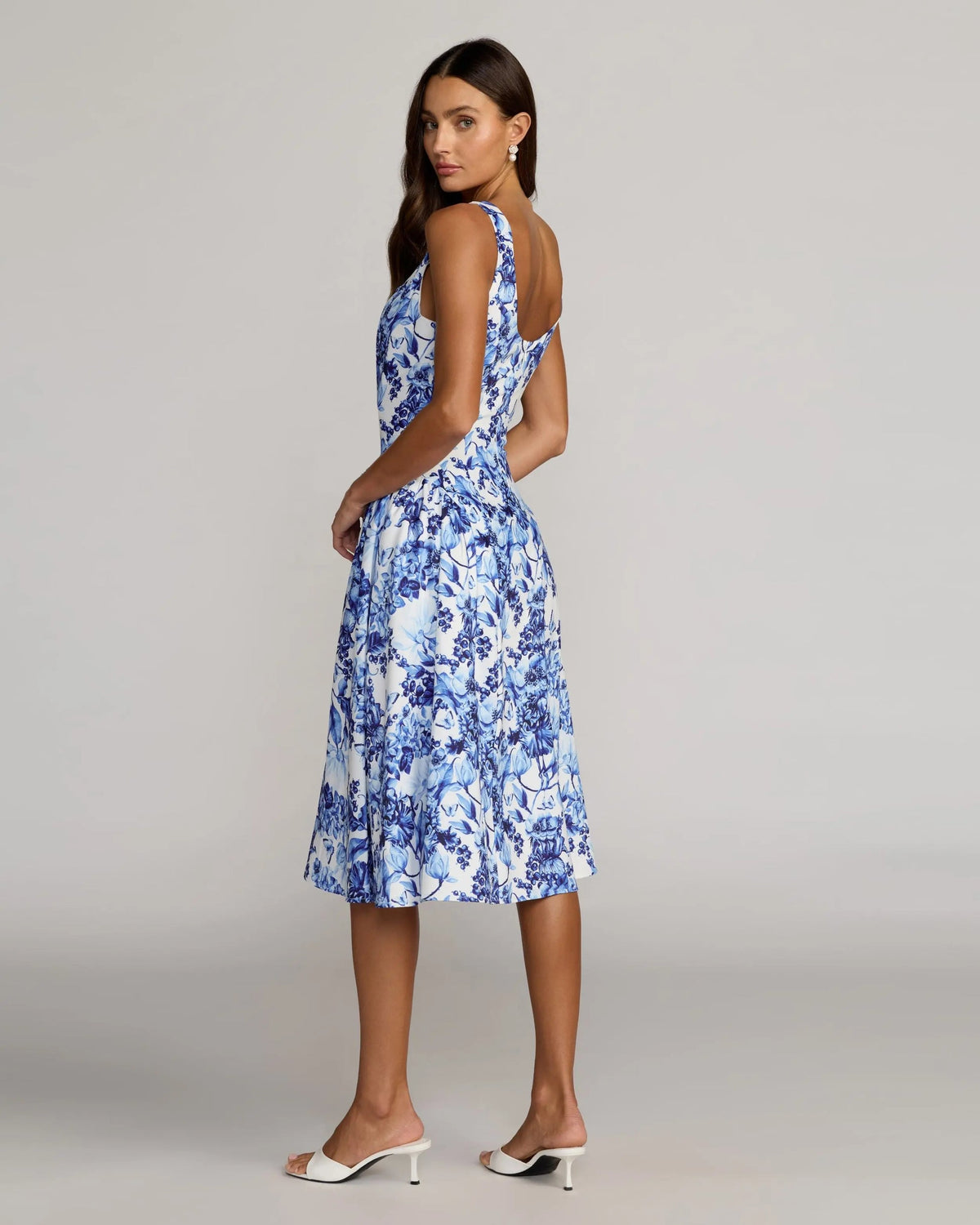 Back view of the Blue Multi variation highlighting the scoop back and fluid midi-length skirt.