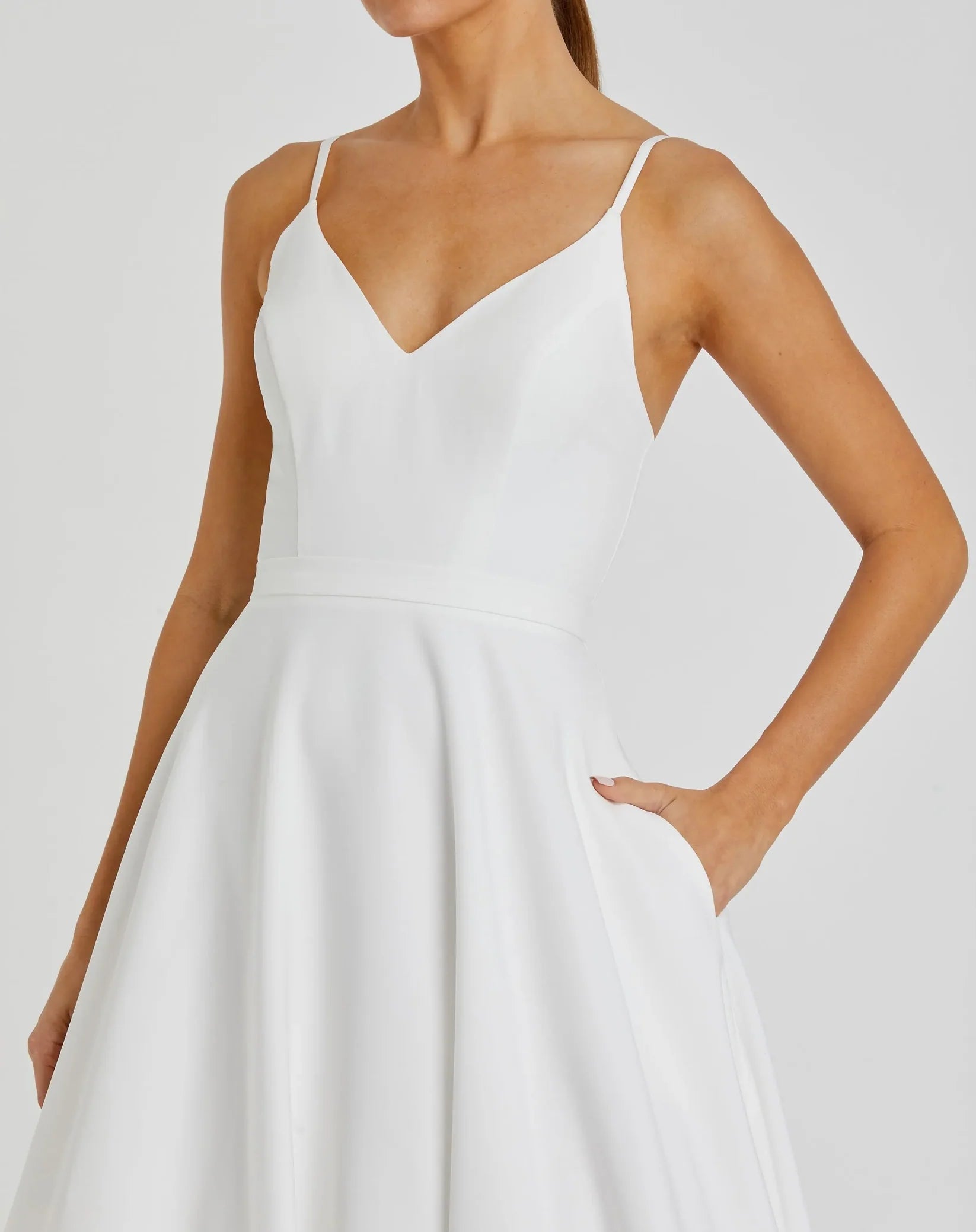 White dress worn by a model on a plain background