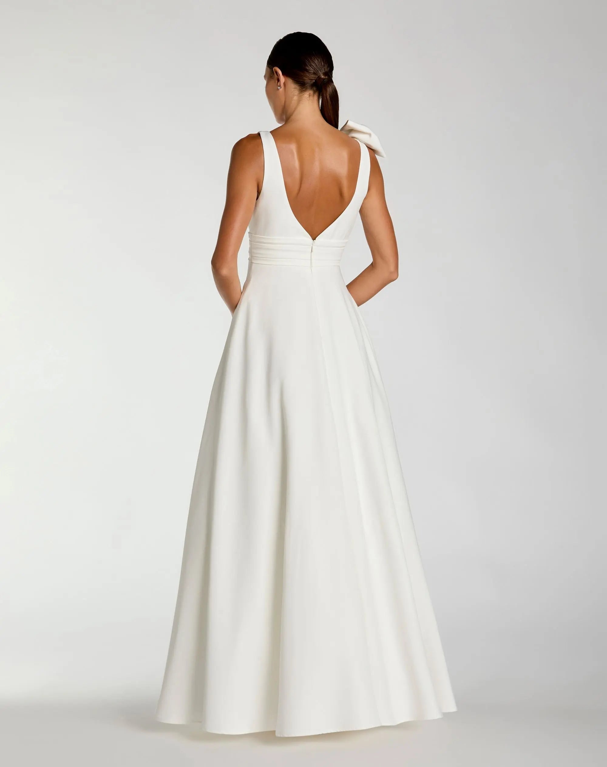 Mac Duggal #49972 white sleeveless plunge neck ball gown with bow detail