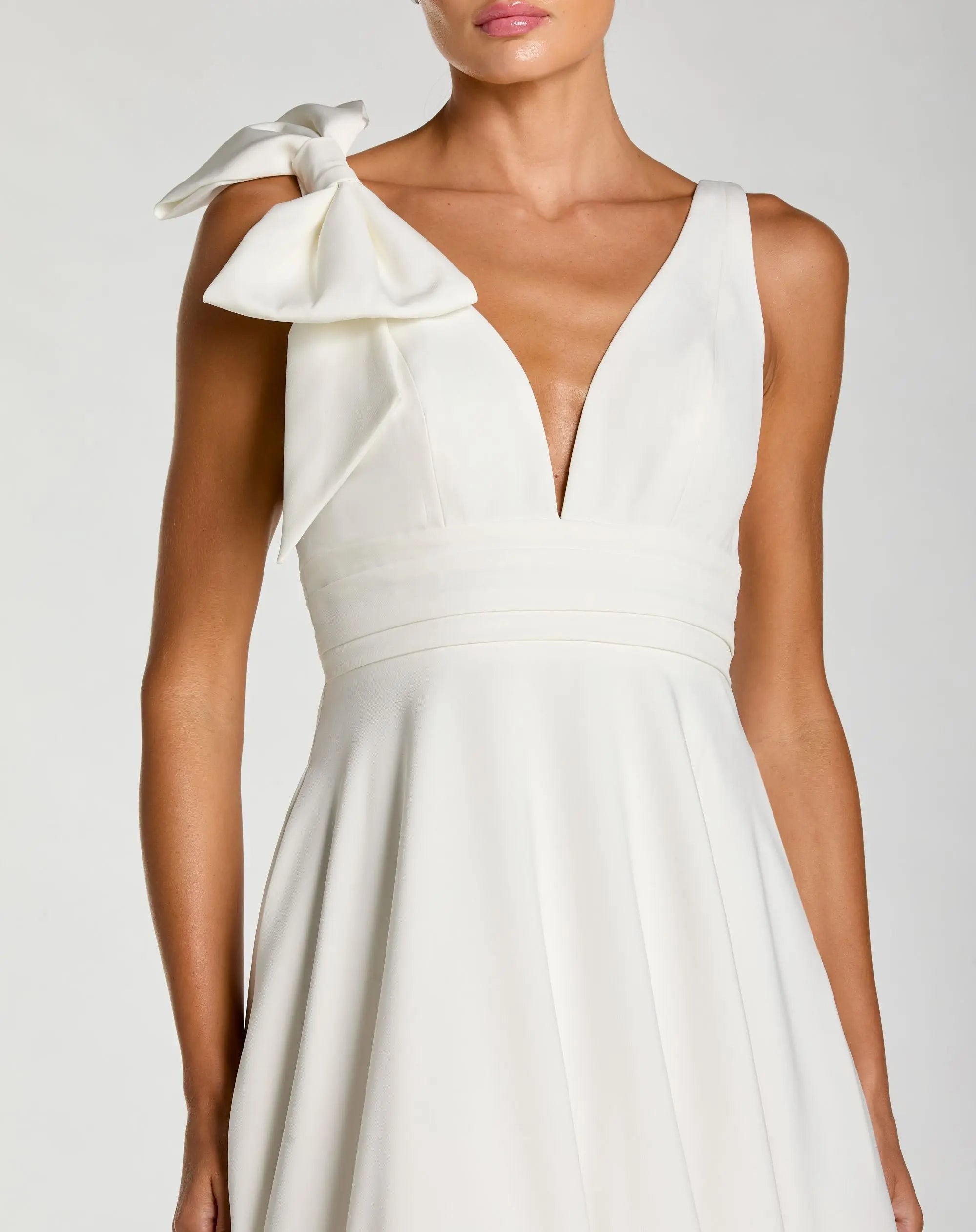 Mac Duggal #49972 white sleeveless plunge neck ball gown with bow detail