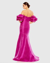 Fuchsia evening gown with ruffled shoulders on a white background
