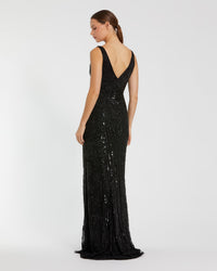 A woman modeling a floor-length black sequined evening gown from the back, showing a deep V-neckline and fitted silhouette, against a plain light gray studio background.