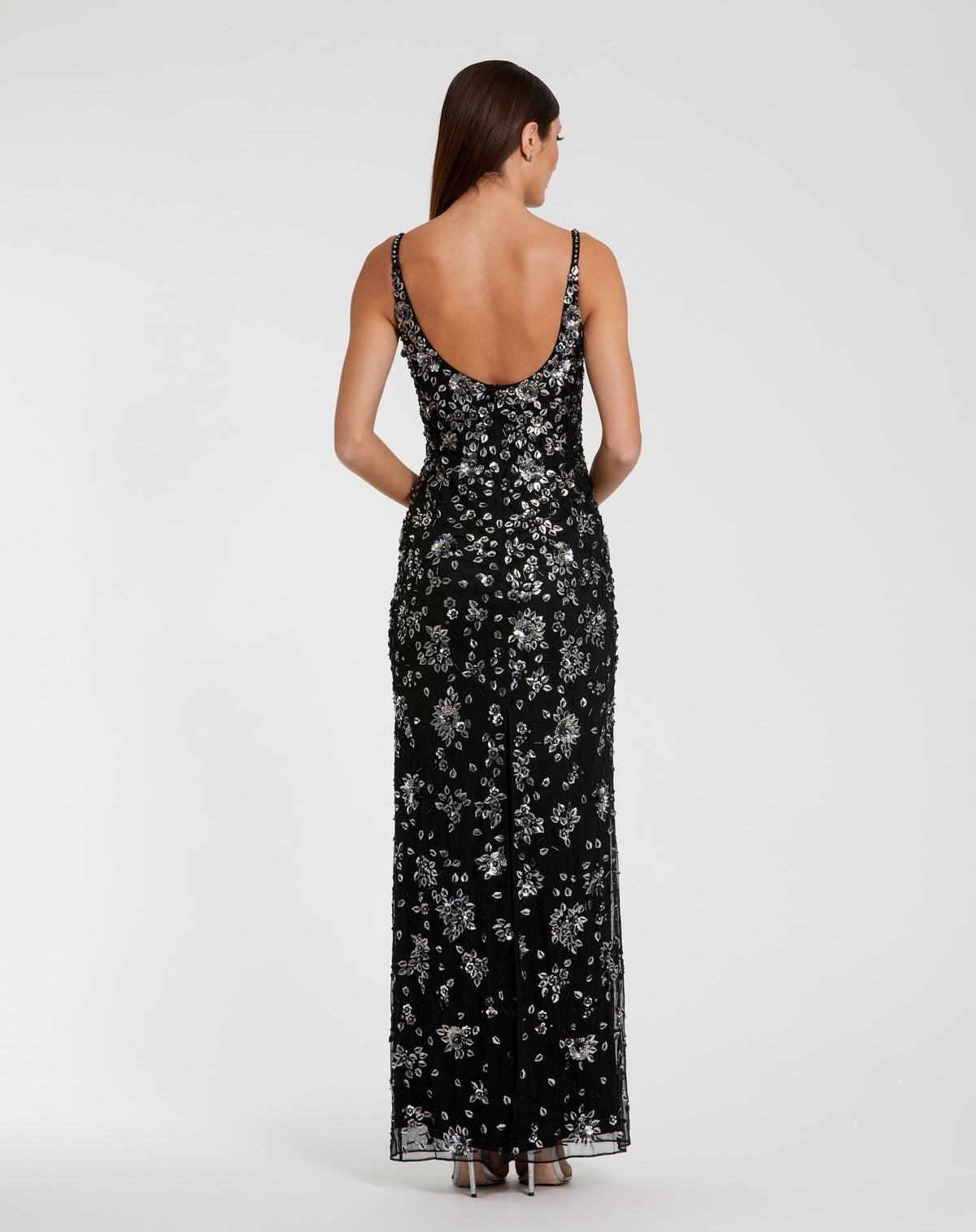 Woman wearing a black floral dress on a white background