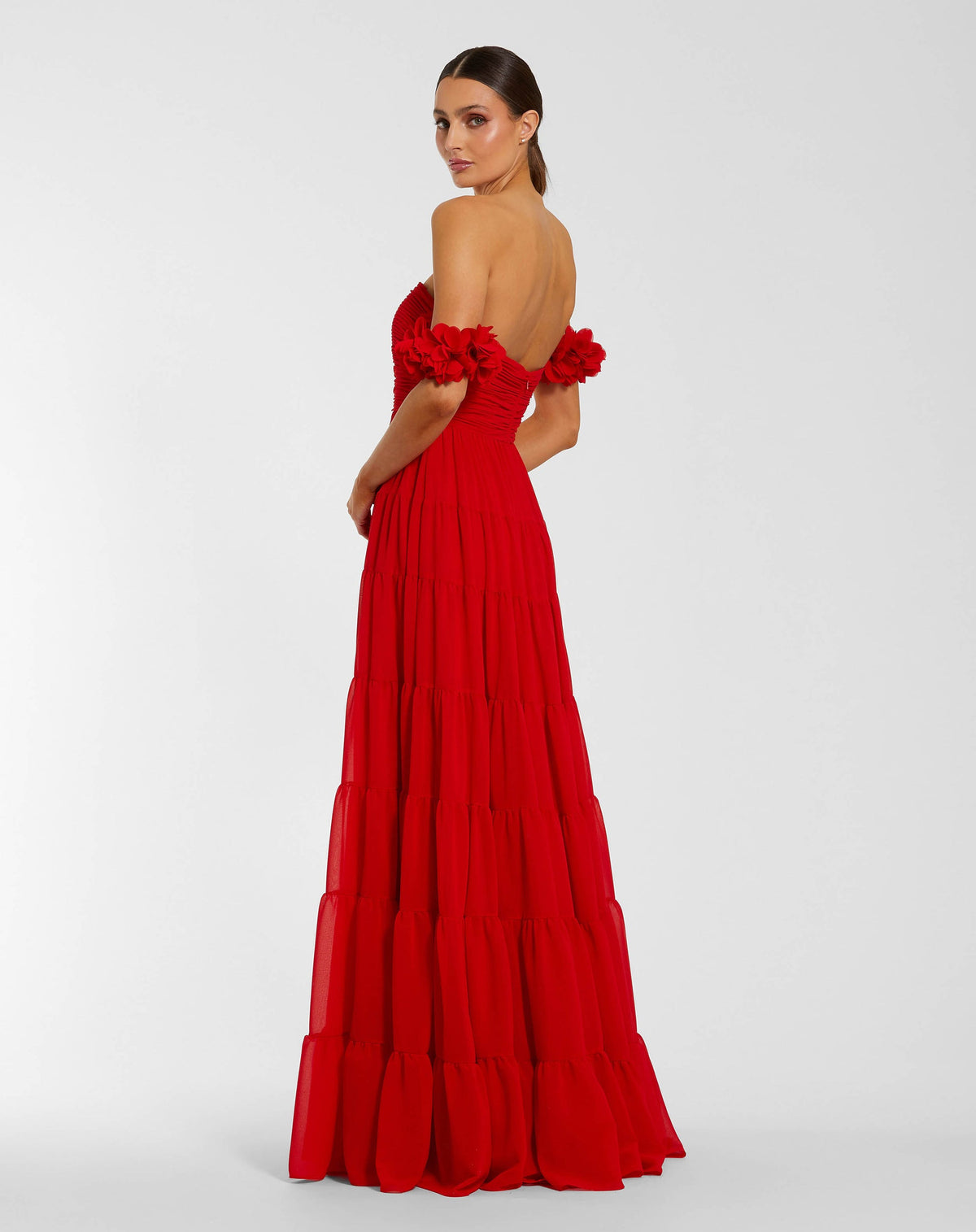 Back view of a red floor-length chiffon gown featuring a concealed back zipper and tiered skirt design.