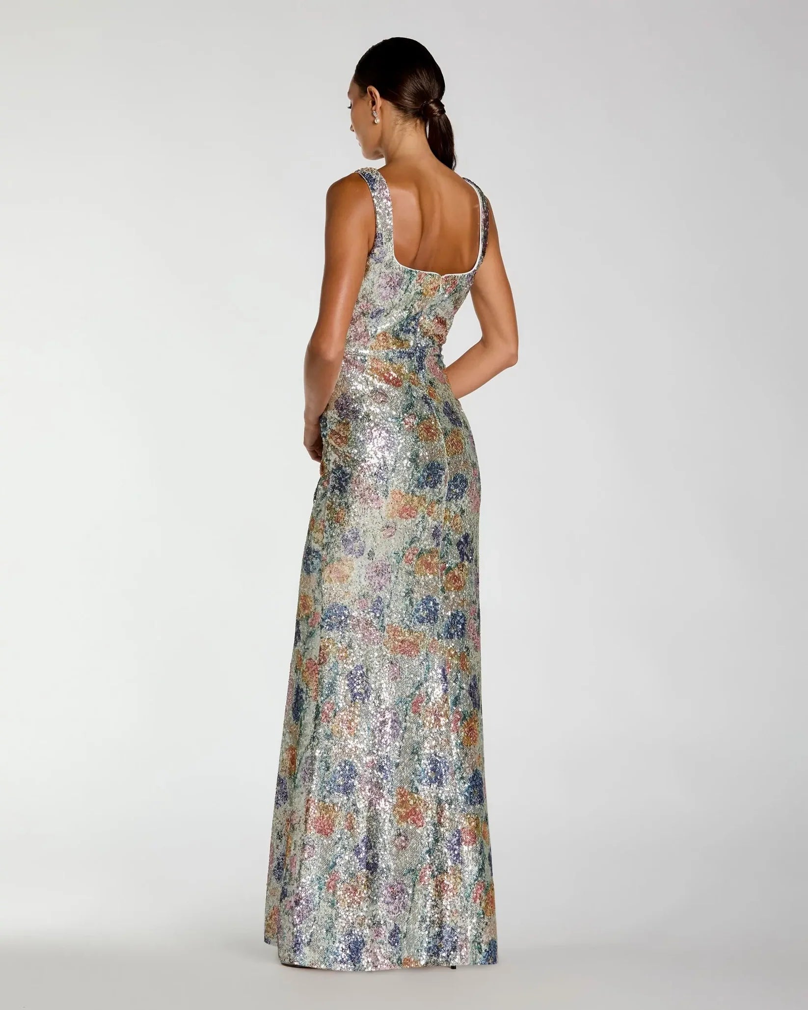 Woman wearing a floral dress with a white background