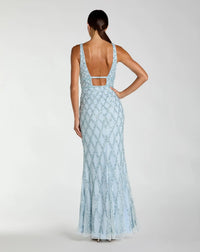 Woman wearing a light blue lace dress with a cutout back on a white background