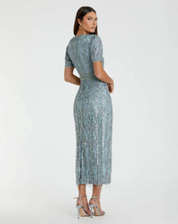 Woman wearing a patterned dress on a white background