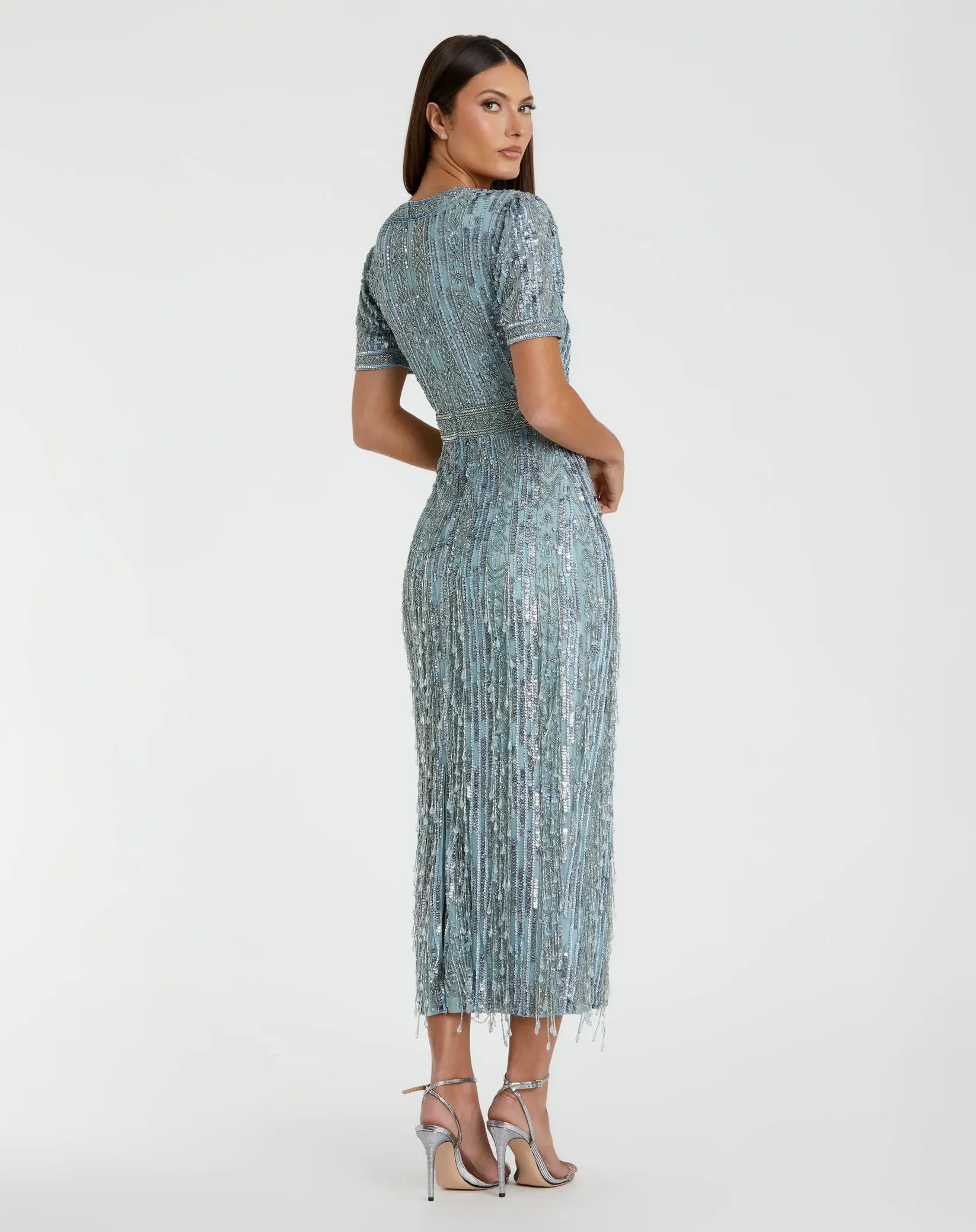 Woman wearing a patterned dress on a white background