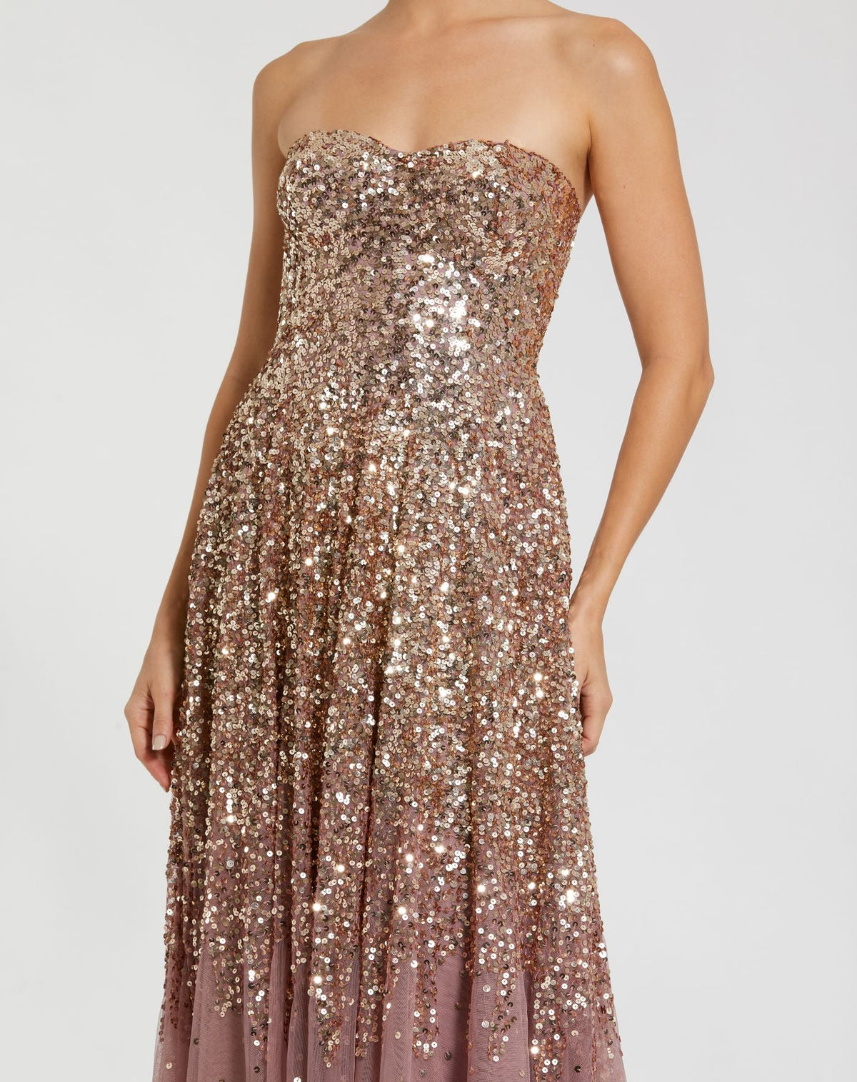 Close up shot of a model wearing a Gold Amethyst ombré A-line gown.