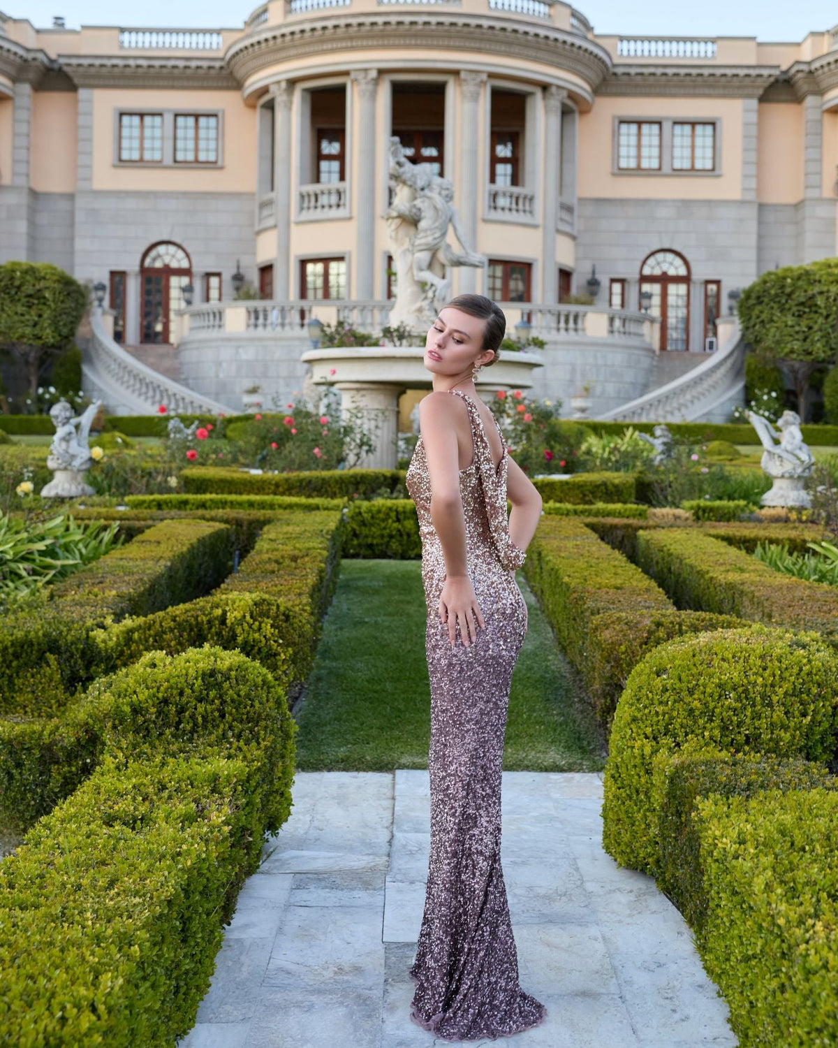 Close-up of a model wearing a high-neck Gold Amethyst ombré sequin gown.