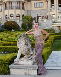 Back view of a model in a Gold Amethyst ombré sequin gown showing the cowl back design.
