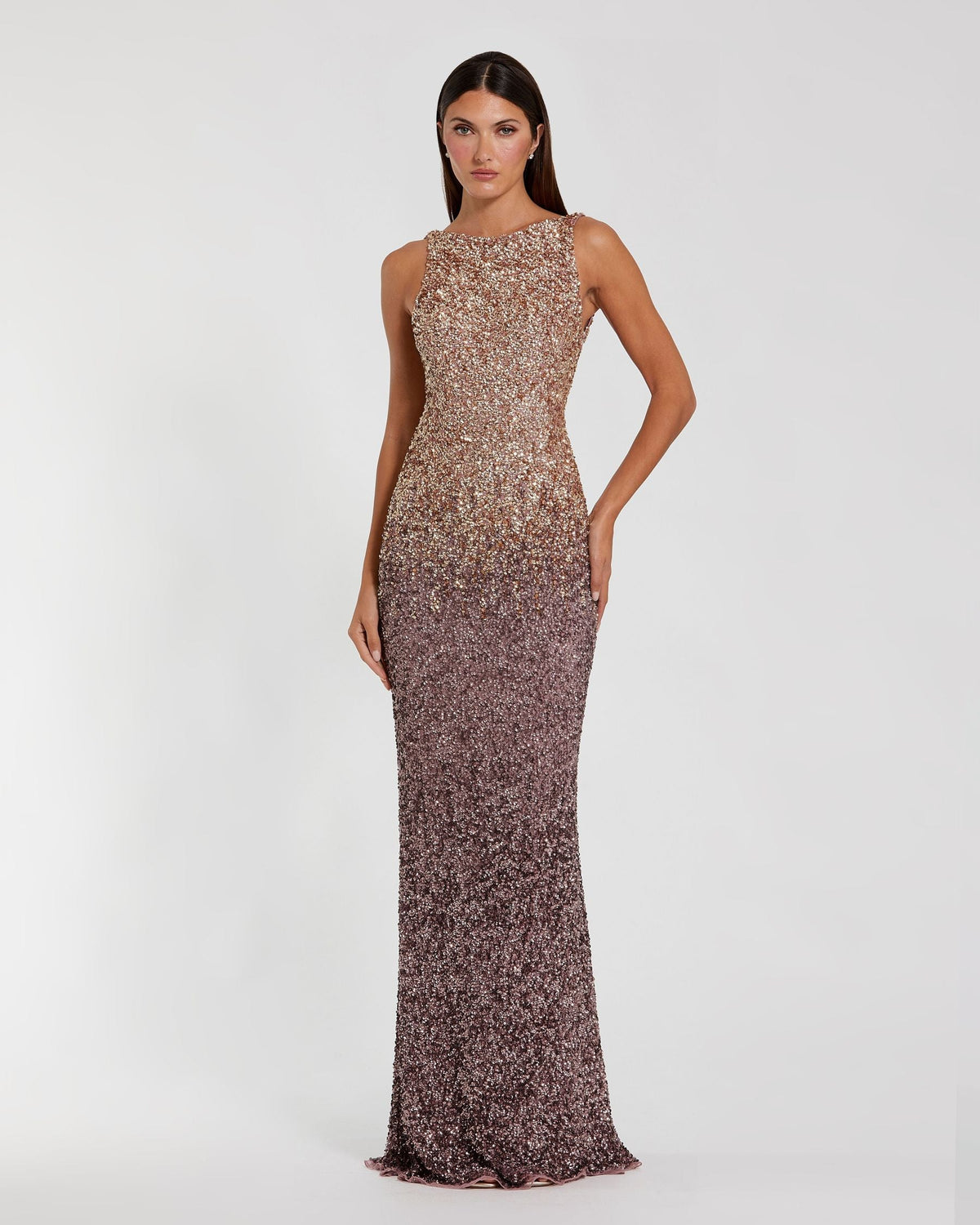 Model posing beside a stone lion sculpture in a Gold Amethyst ombré sequin column gown.