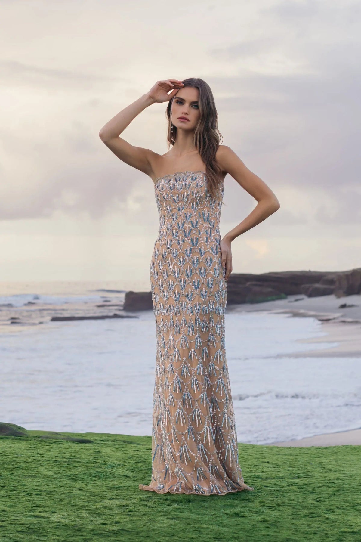 Lifestyle portrait of model in Mac Duggal 6250 nude silver strapless beaded gown