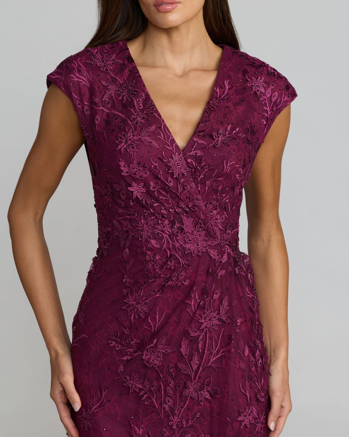 Close-up of the V-neck bodice and embroidered mesh details with heat-set rhinestones on an Amethyst gown.