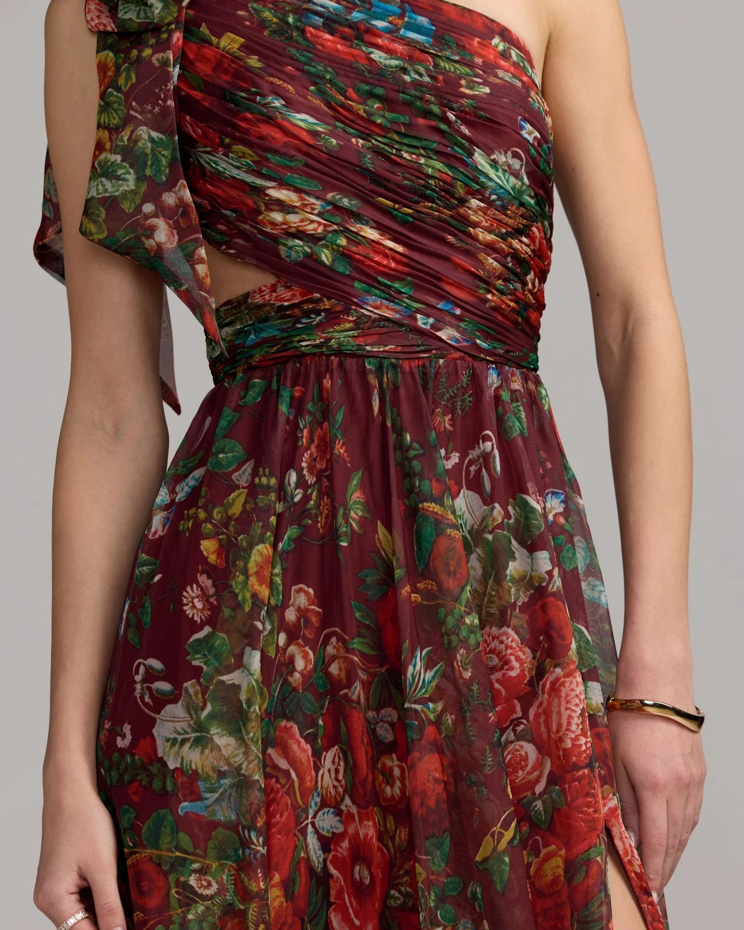 Multicolored floral dress with cut-out design on a neutral background