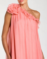 Coral pink dress with ruffled shoulders on a plain background