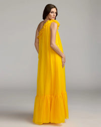 Woman wearing a yellow one-shoulder dress against a gray background