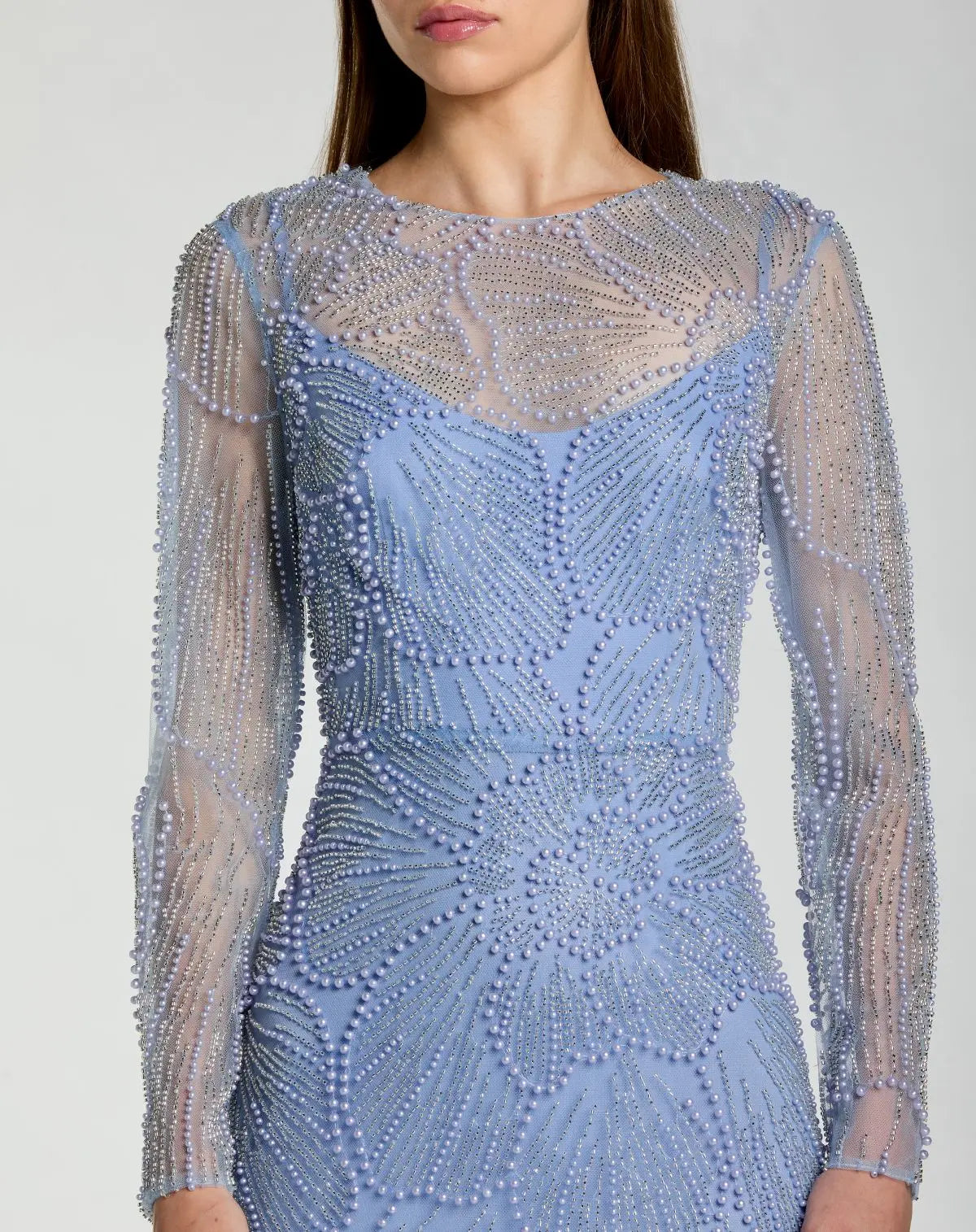 Close-up detail of high round neckline and intricate flower petal pearl and bead embellishments on Mac Duggal 69012 gown