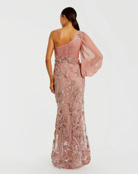 Woman wearing a pink one-shoulder gown with floral embroidery on a white background