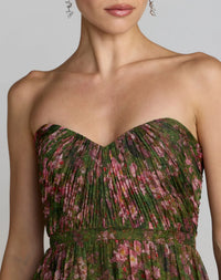 Woman wearing a strapless floral dress with a neutral background
