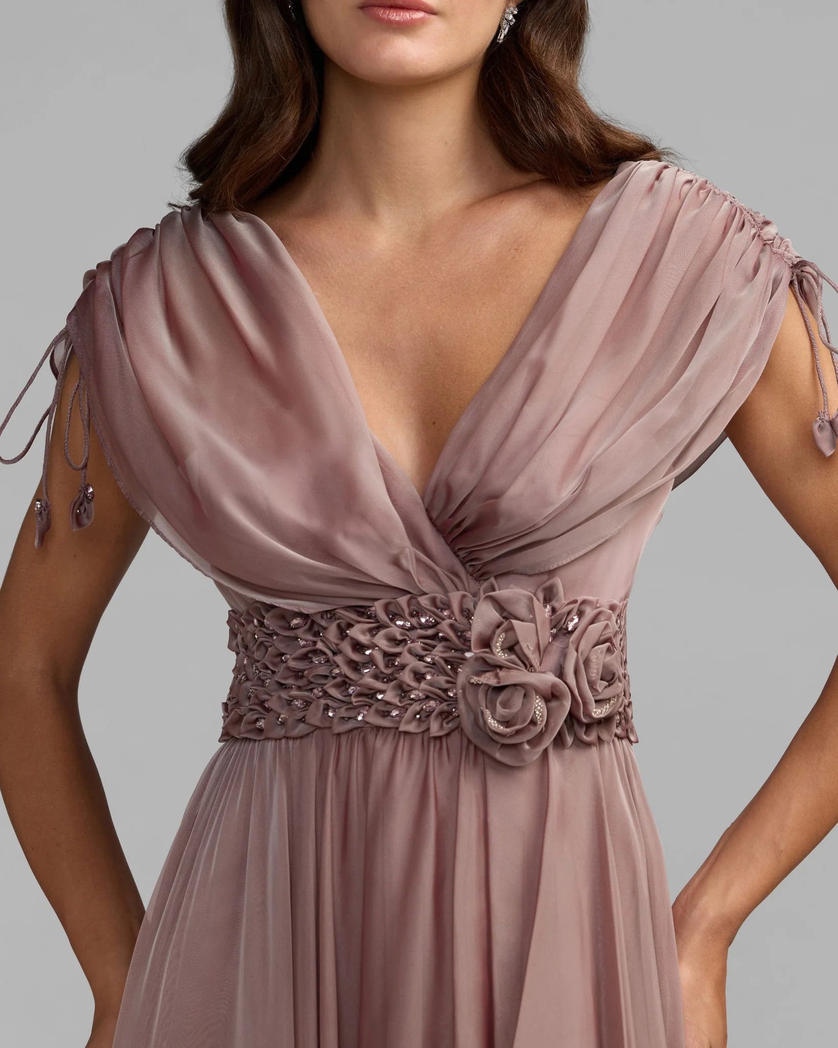 Mauve evening gown with floral details on a gray background