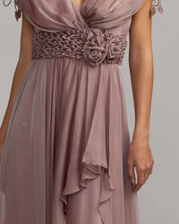 Mauve evening gown with floral and beaded details on a plain background