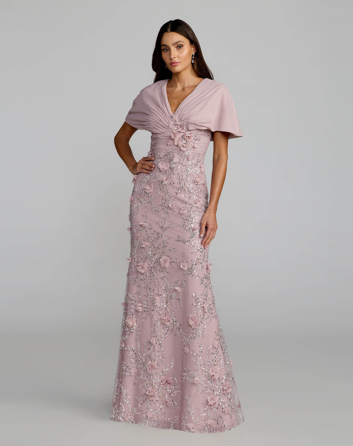 Full-length front studio view of the rose gown featuring a fitted silhouette and cape sleeves.