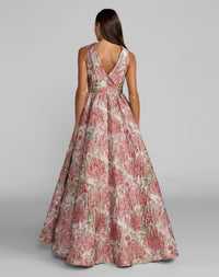Woman wearing a floral dress on a gray background
