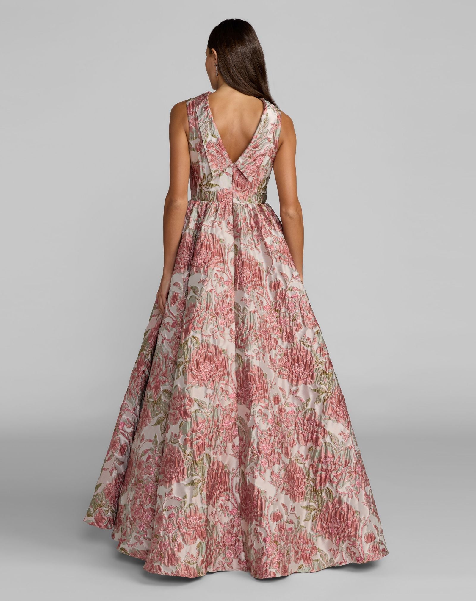 Woman wearing a floral dress on a gray background