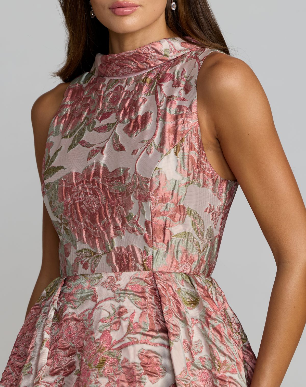 Woman wearing a floral dress with a neutral background