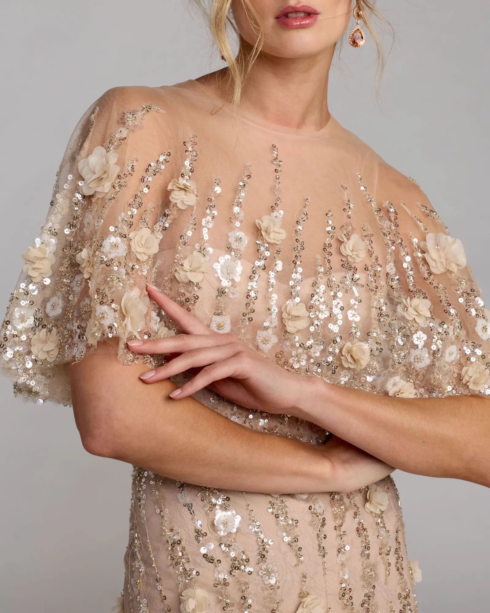 Elegant dress with floral and sequin details on a plain background