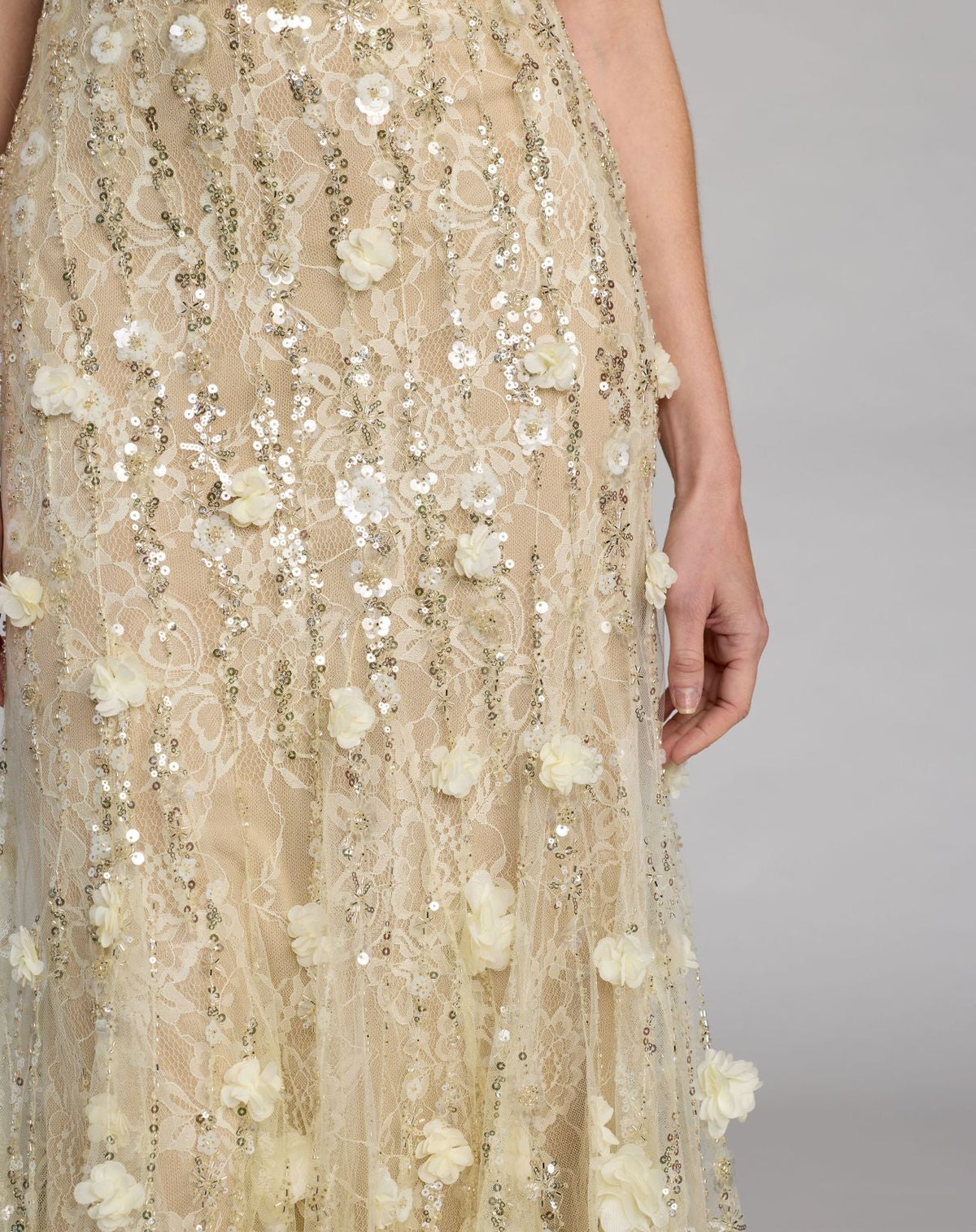 Detailed close-up of allover sequin and beadwork on the skirt with dimensional 3D flowers on Mac Duggal 69189 gown