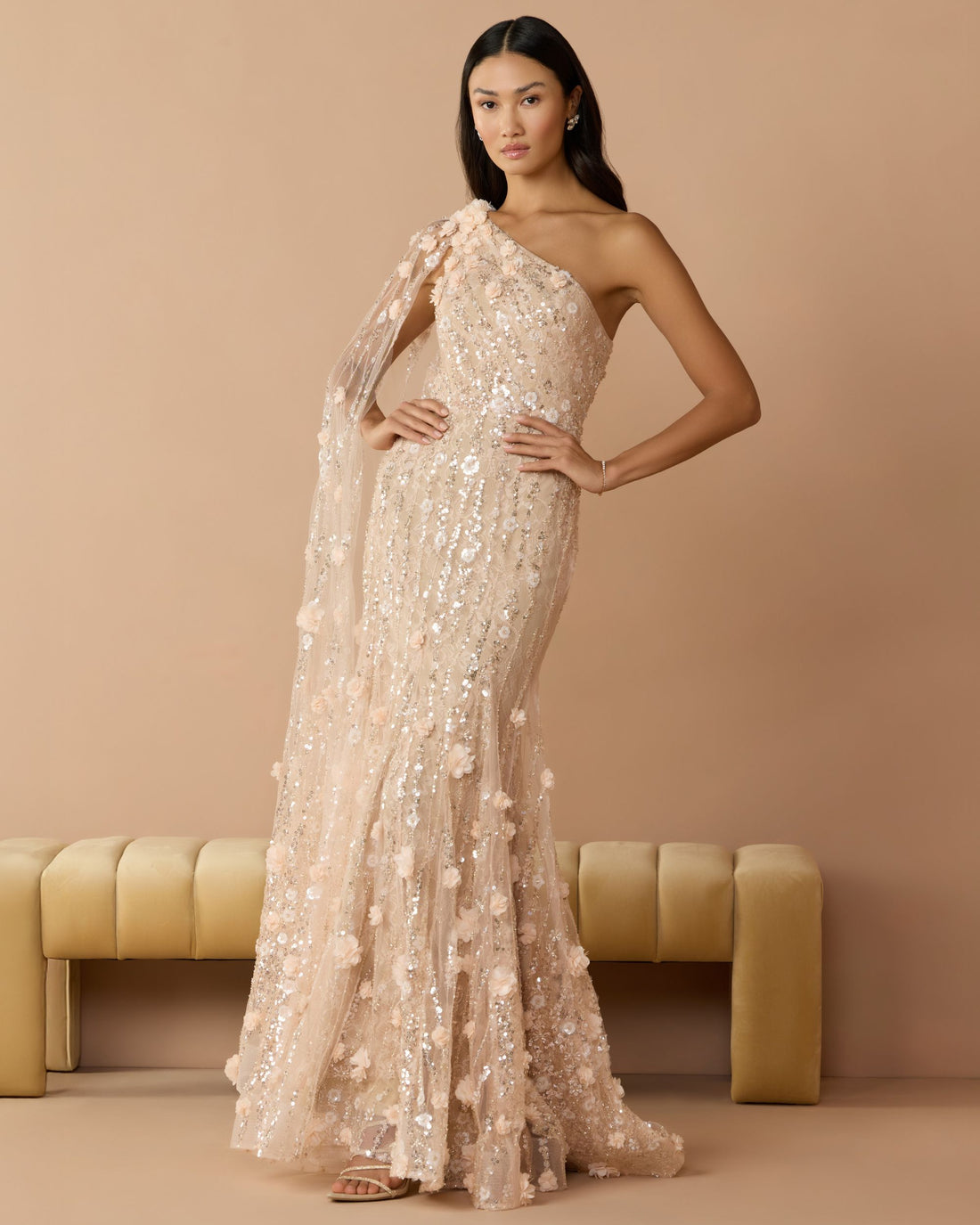 Full-length front studio view of the blush mermaid gown with floral embroidery and flutter cap sleeves.
