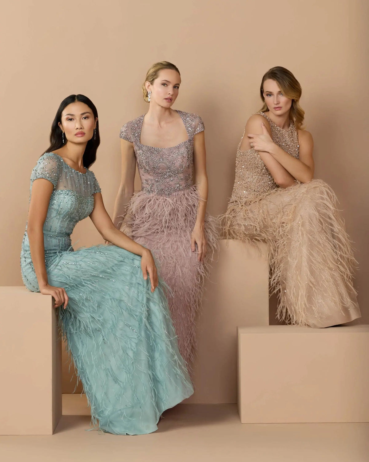 Studio lifestyle shot of a model wearing the Seafoam feathered gown against a neutral background.