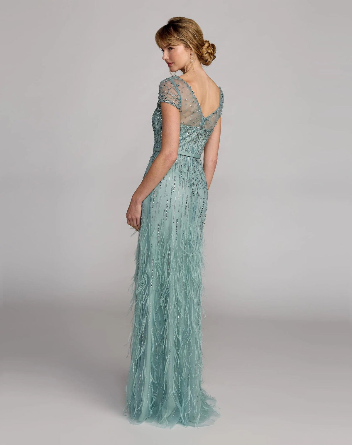 Rear view of the Seafoam gown highlighting the V-back design and textured feathered train.