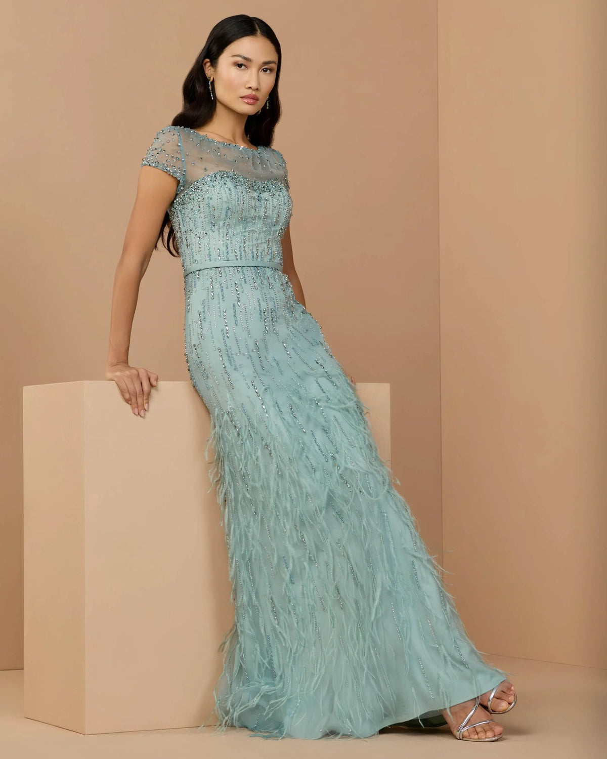 Full-length front view of the Seafoam embellished mesh gown with feathered skirt and cap sleeves.