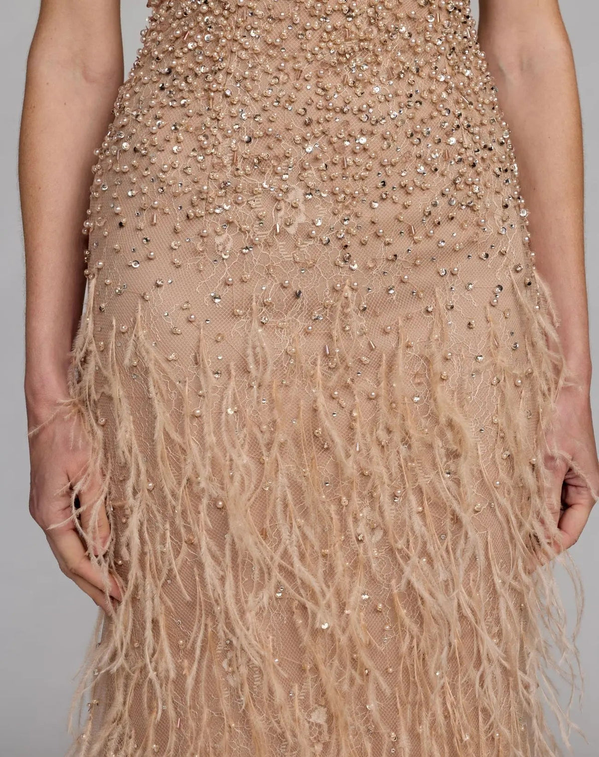 Close-up studio shot highlighting the exquisite hand-applied tonal beadwork and intricate lace patterning on the bodice.