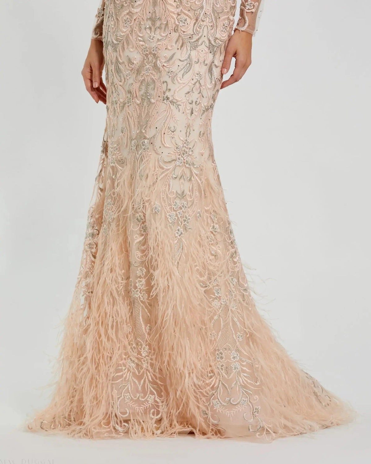 Detailed view of the feather trim hem and embroidered mesh fabric on Mac Duggal 79267 blush gown"