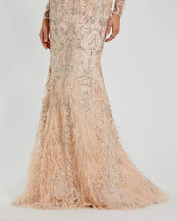Detailed view of the feather trim hem and embroidered mesh fabric on Mac Duggal 79267 blush gown"