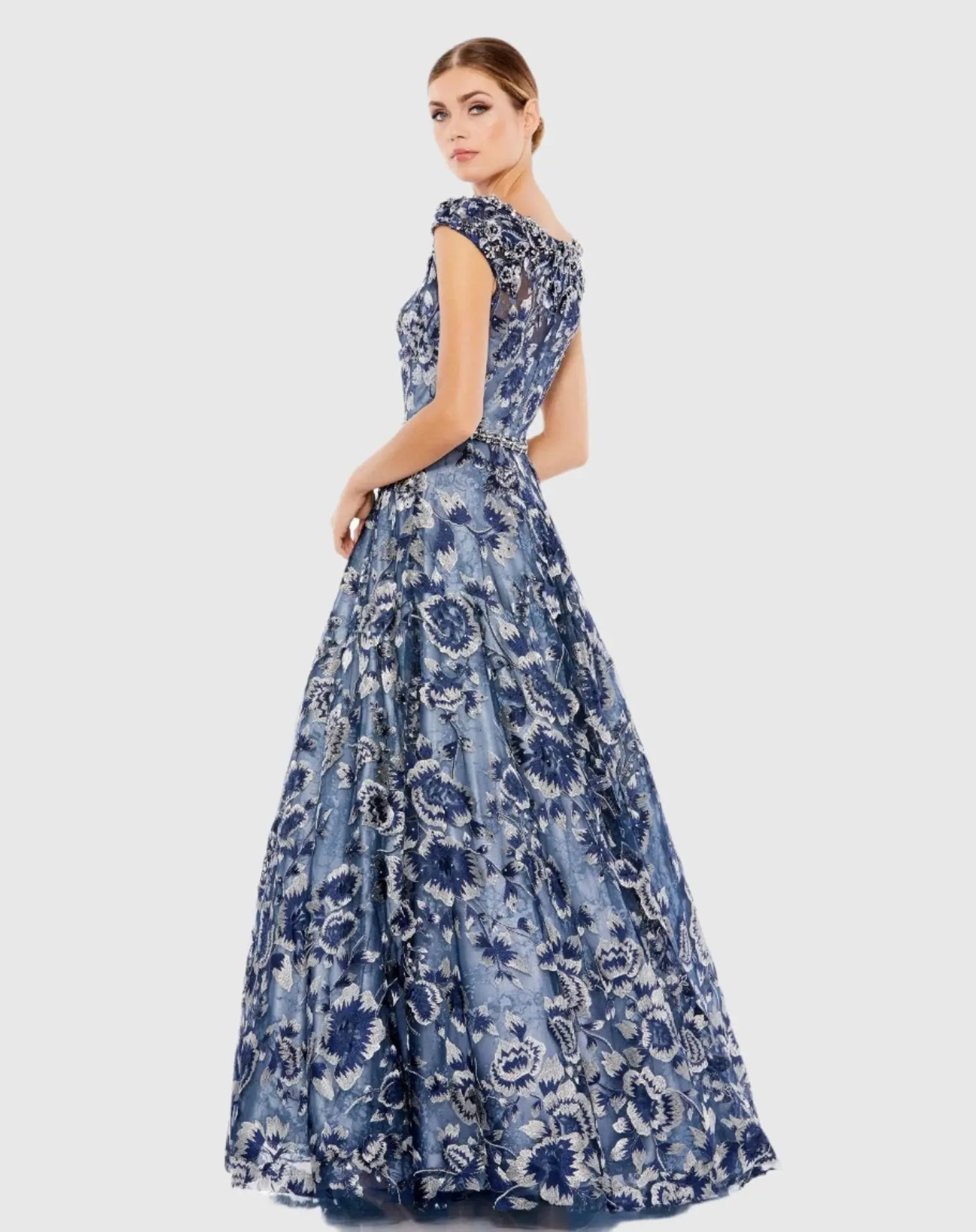 Woman wearing a blue floral dress on a light gray background