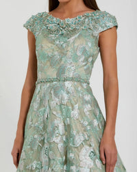 Green floral lace dress on a white background