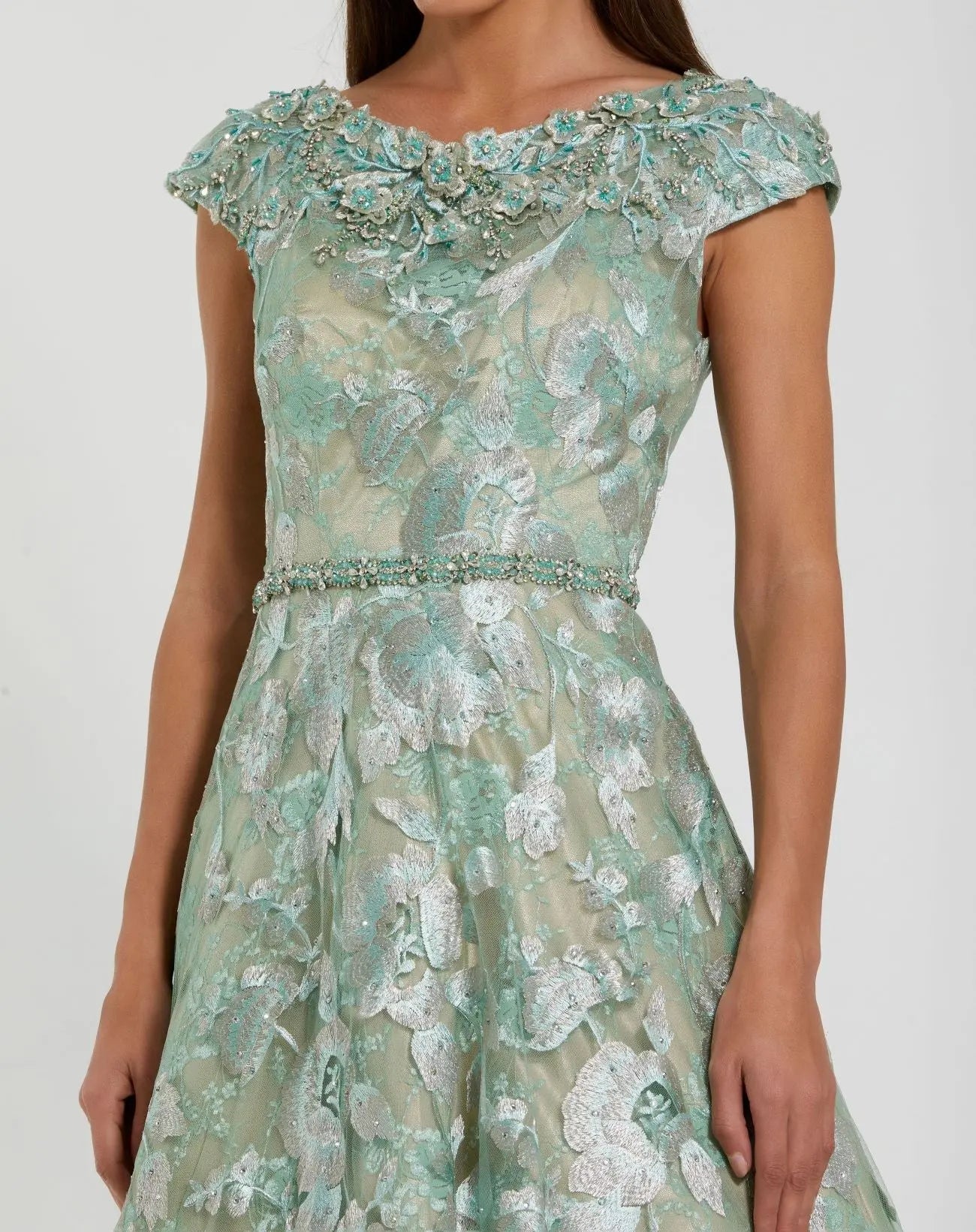 Green floral lace dress on a white background